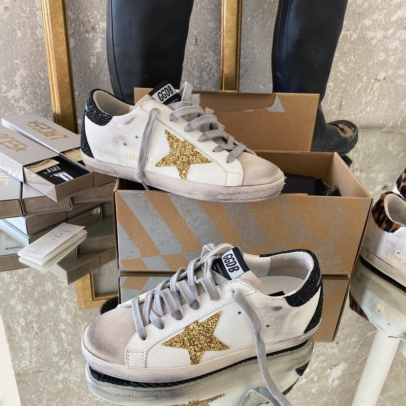 golden goose S*per-star sneakers with golden glitter and black heel tab